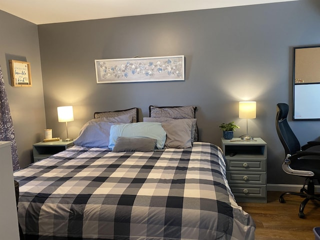 bedroom with dark wood finished floors