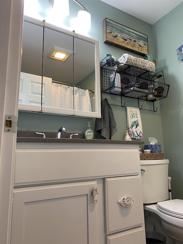 full bath featuring toilet and vanity