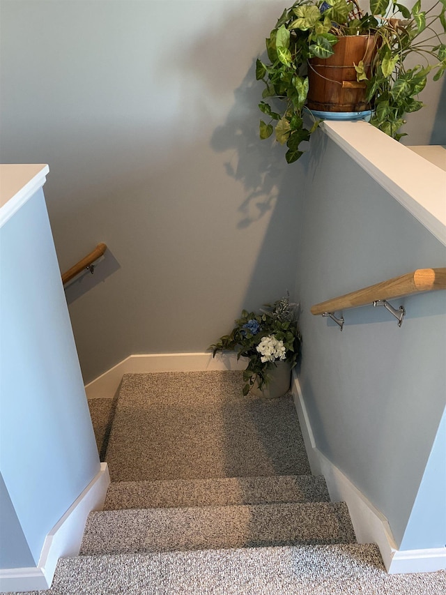 staircase featuring baseboards