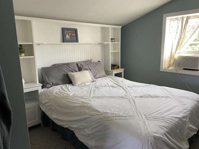 carpeted bedroom featuring cooling unit and lofted ceiling