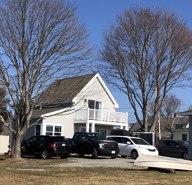 view of property exterior with uncovered parking