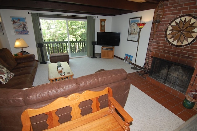 living room with a fireplace, brick wall, dark colored carpet, and beam ceiling