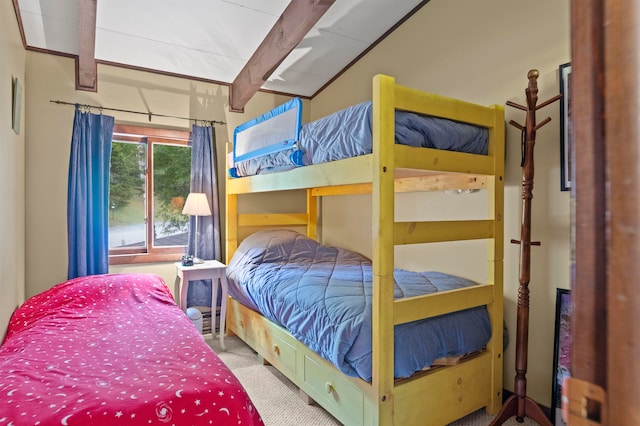 carpeted bedroom featuring vaulted ceiling with beams