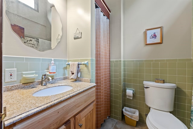 bathroom with backsplash, tile patterned floors, vanity, tile walls, and toilet