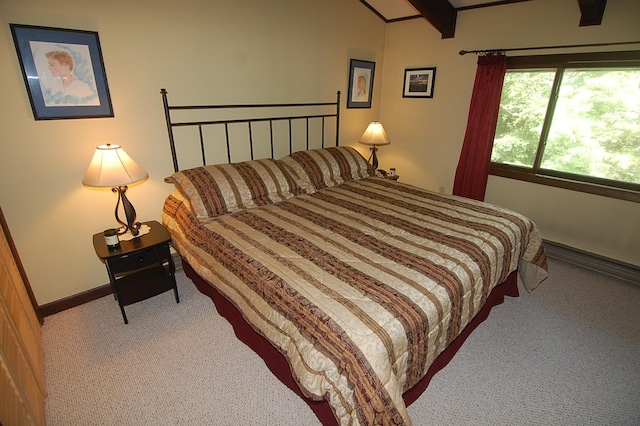 carpeted bedroom with beamed ceiling