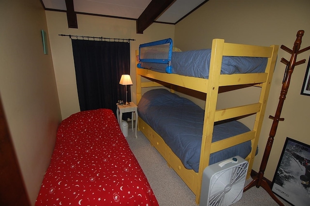 bedroom featuring beam ceiling and carpet flooring