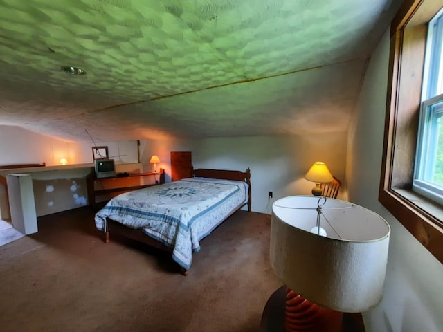 carpeted bedroom featuring lofted ceiling