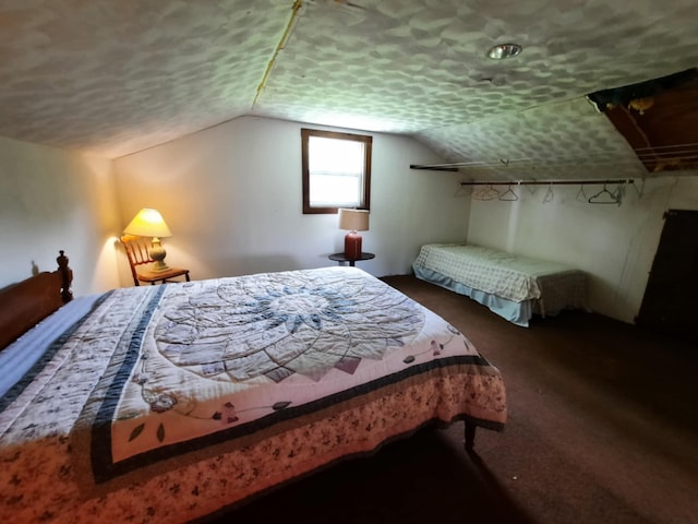 carpeted bedroom featuring lofted ceiling and a textured ceiling