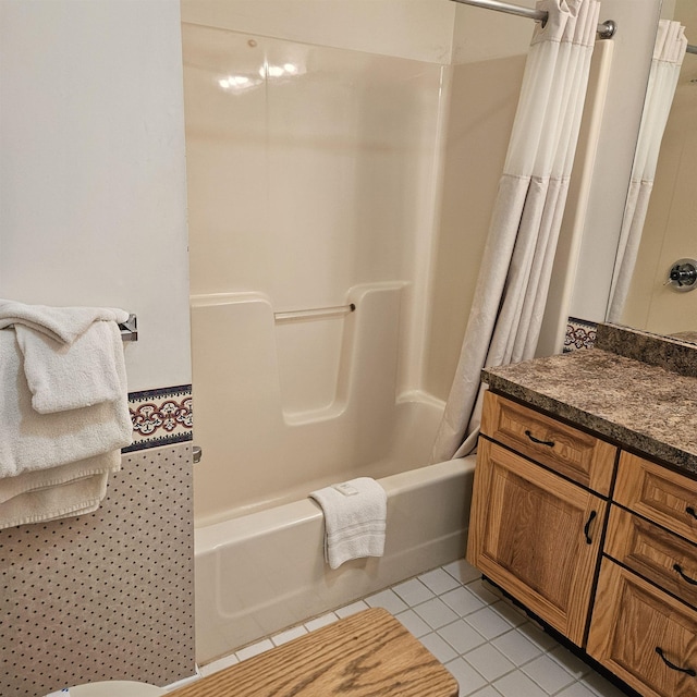 bathroom featuring shower / bath combo with shower curtain, vanity, and tile patterned floors