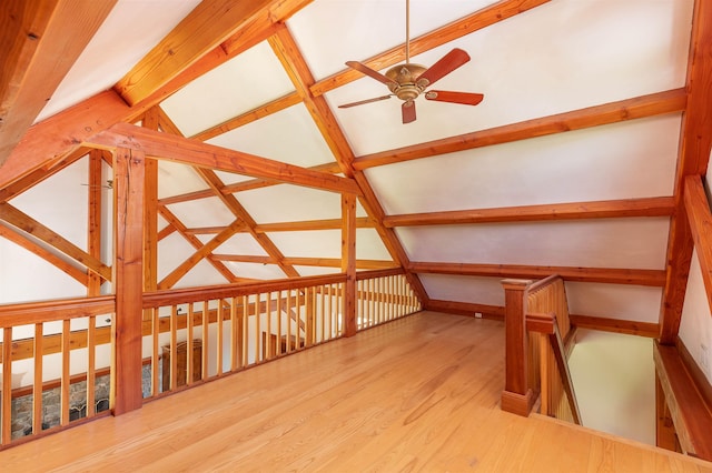 additional living space featuring lofted ceiling with beams, ceiling fan, and light hardwood / wood-style floors