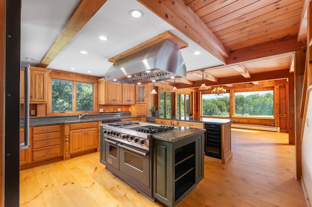 kitchen with double oven range, light wood-type flooring, island exhaust hood, and a kitchen island