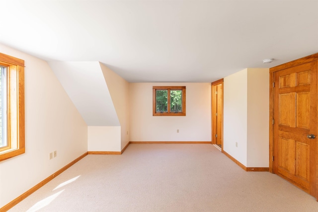 additional living space with light colored carpet