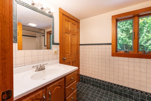 bathroom with vanity and tile walls