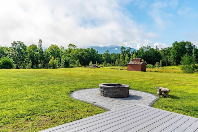 view of yard with a storage shed and a fire pit