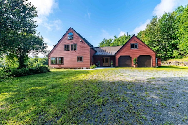 view of front of home with a garage and a front lawn