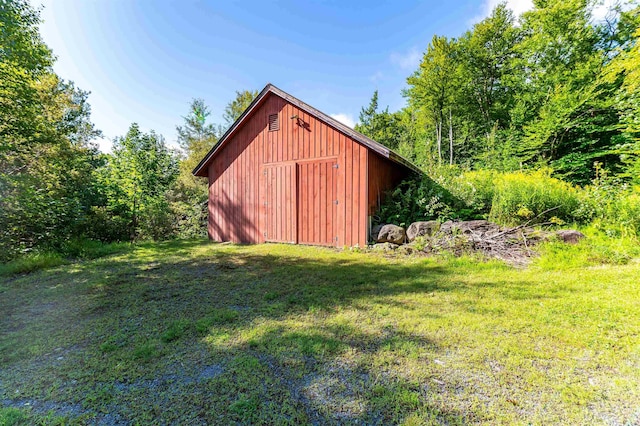 view of outbuilding with a lawn