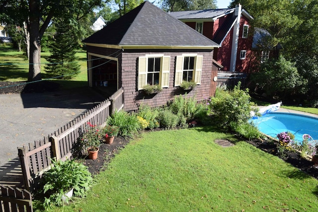 exterior space with a yard and a fenced in pool