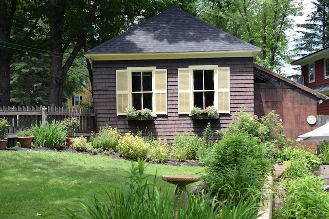 view of outbuilding with a yard