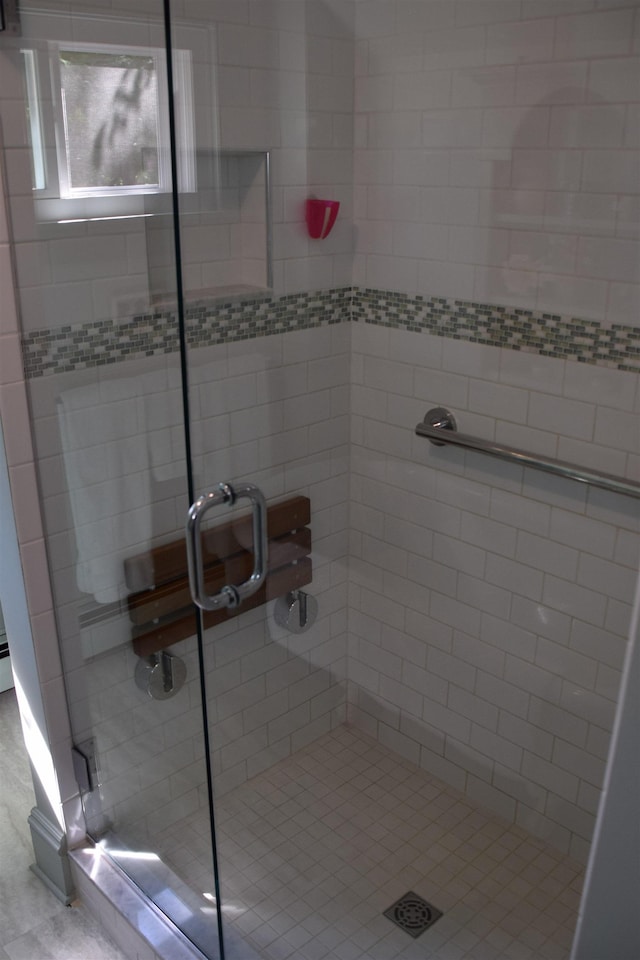 bathroom with a shower with shower door