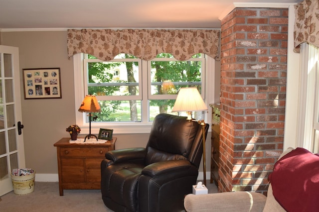 sitting room featuring crown molding and light carpet