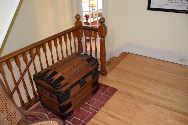 stairs with hardwood / wood-style floors