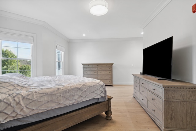 bedroom with ornamental molding and light hardwood / wood-style floors