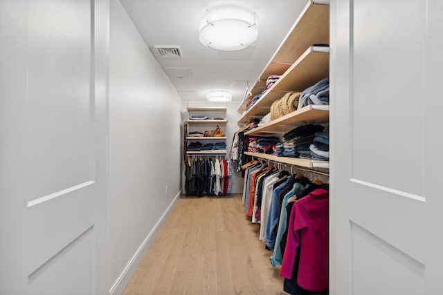 spacious closet featuring light hardwood / wood-style floors