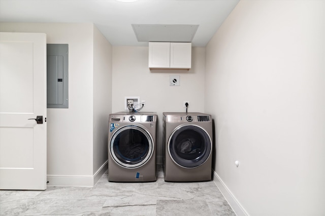 laundry room with electric panel, washer and clothes dryer, light tile patterned floors, and cabinets