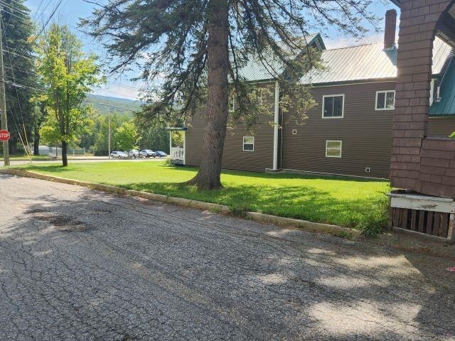 view of side of home featuring a lawn