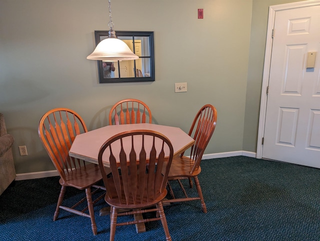 carpeted dining space featuring baseboards