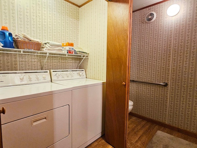 laundry area with crown molding, dark hardwood / wood-style floors, and independent washer and dryer