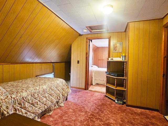 bedroom featuring carpet floors, wooden walls, and vaulted ceiling