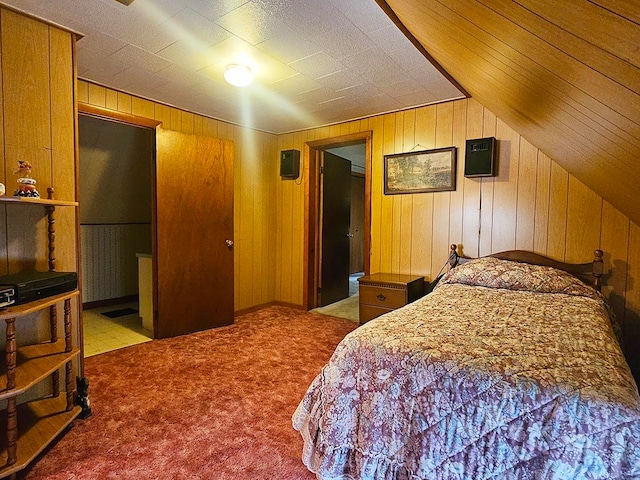 bedroom featuring wooden walls, vaulted ceiling, and light colored carpet