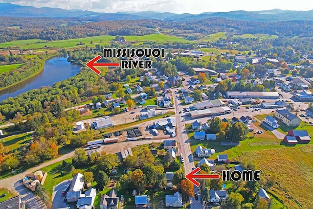 aerial view featuring a water and mountain view