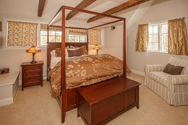 carpeted bedroom featuring beamed ceiling and multiple windows