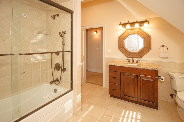 full bathroom featuring tile patterned floors, vanity, toilet, and enclosed tub / shower combo