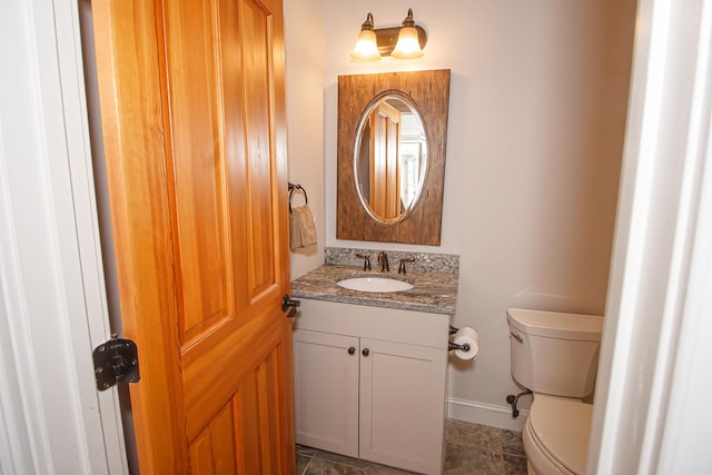 bathroom featuring vanity, tile patterned flooring, and toilet