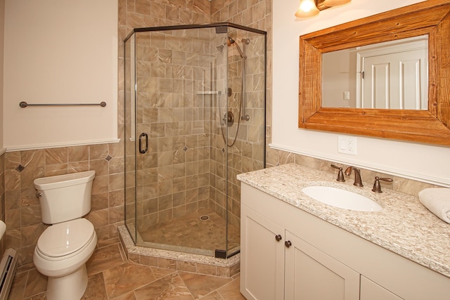 bathroom featuring toilet, tile walls, an enclosed shower, tile patterned floors, and vanity