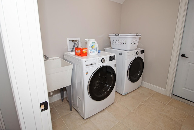 laundry room featuring sink, light tile patterned flooring, and independent washer and dryer