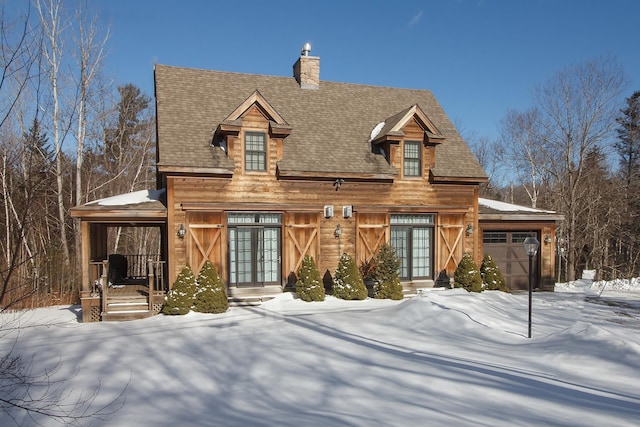 view of front facade featuring french doors and a garage