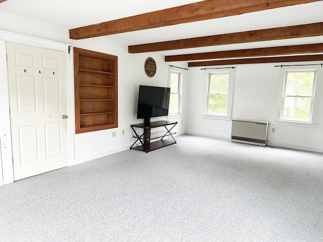 10 Hawthorne St, Plymouth, NH 03264 - unfurnished living room featuring baseboards, beam ceiling, heating unit, and built in shelves