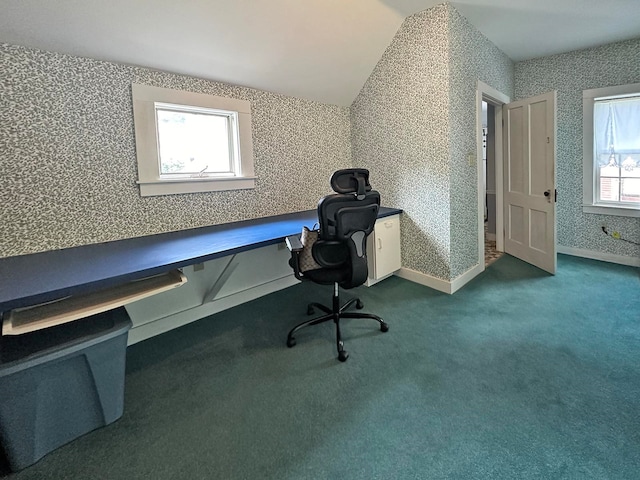 unfurnished office featuring lofted ceiling, plenty of natural light, and carpet flooring