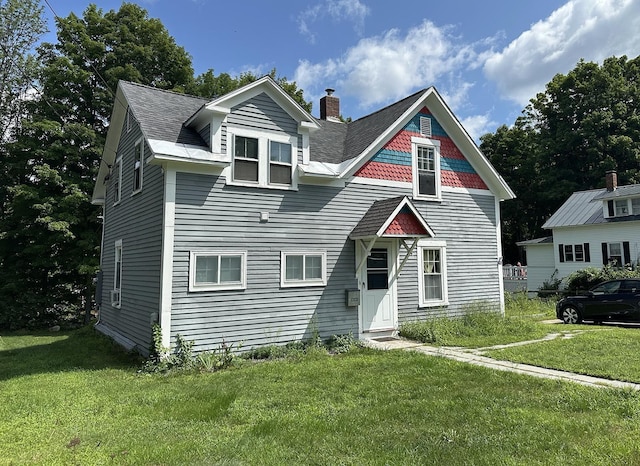 10 Hawthorne St, Plymouth, NH 03264 - view of front facade featuring a chimney, a front yard, and a shingled roof