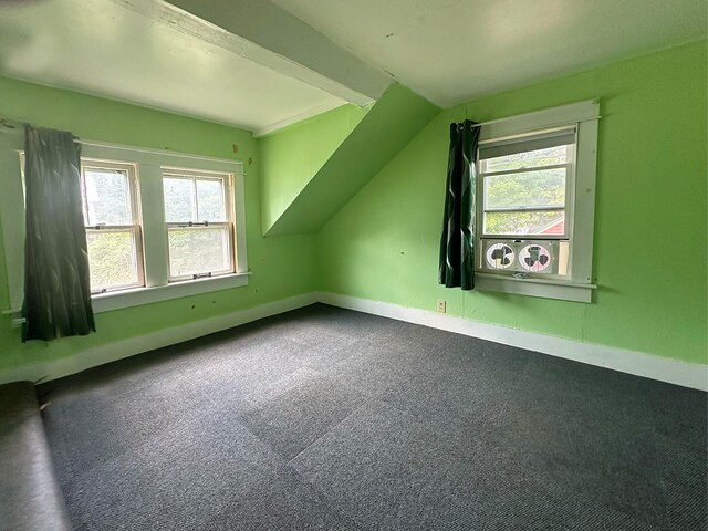 additional living space featuring carpet floors and lofted ceiling with beams