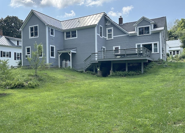10 Hawthorne St, Plymouth, NH 03264 - back of house with a standing seam roof, a deck, a chimney, and a lawn