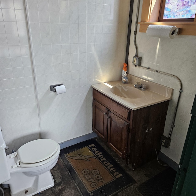 70 High St, Plainfield, VT 05667 - half bath with tile walls, toilet, and vanity