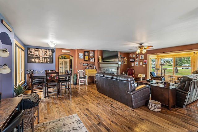 living room with ceiling fan and wood-type flooring