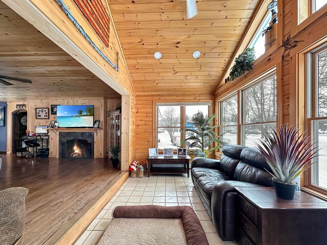 living room featuring ceiling fan, radiator heating unit, dark hardwood / wood-style flooring, and a high end fireplace