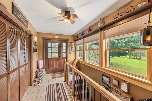 tiled entryway featuring ceiling fan