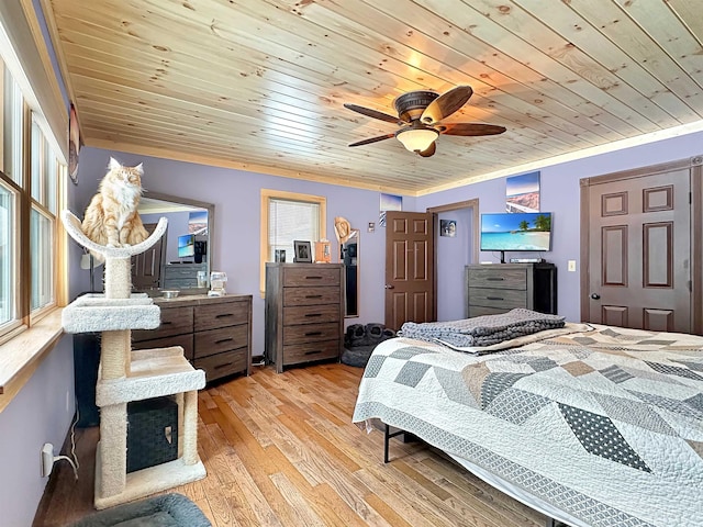 bedroom with light wood-type flooring, wood ceiling, multiple windows, and ornamental molding